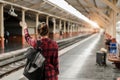 Young Asian woman backpacker traveler walking alone at train station platform with backpack. Asian woman waiting train Royalty Free Stock Photo