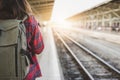 Young Asian woman backpacker traveler walking alone at train station platform with backpack. Royalty Free Stock Photo