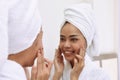 Young asian woman with bath towels cleanses her face Royalty Free Stock Photo