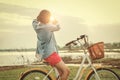 young asian woman on bicycle look at hand frame view