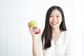 Young Asian woman bite green apple show Strong teeth. Royalty Free Stock Photo