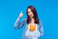 Young asian woman broken arm in sling right arm thumbs up. A woman showing a painful expression from a broken arm health care and Royalty Free Stock Photo
