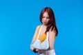 Young asian woman broken arm in sling. A woman showing a painful expression from a broken arm health care and medical concept Royalty Free Stock Photo
