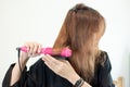 Young asian woman is holding Hair straighteners. Royalty Free Stock Photo