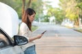 Young Asian woman calling assistance for her broken down car Royalty Free Stock Photo