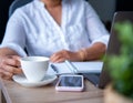 Young Asian woman working from home a hand holding pencil writing agenda note with smartphone, office desk background, Checklist N Royalty Free Stock Photo