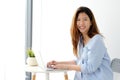 Young asian woman in casual style using laptop computer at home office background , people and technology, working at home, Royalty Free Stock Photo