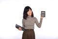 Portrait of young Asian woman casual uniform holding white piggy bank and notebook isolated on white background. Financial and Royalty Free Stock Photo