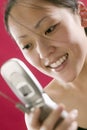 Young Asian woman with cell phone Royalty Free Stock Photo