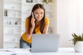 Young Asian Woman With Cellphone And Laptop Working Remotely From Home Office Royalty Free Stock Photo