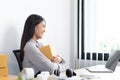 Young Asian woman chatting with a customer on a laptop and displays the product before delivery to confirm the order Royalty Free Stock Photo