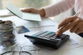 Young Asian woman checking bills, taxes, bank account balance and calculating credit card expenses. Family expenses concept Royalty Free Stock Photo