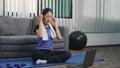 Young Asian woman chooses to listen to music while he is exercising at home