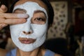 Asian Woman With Cleansing Mask On Her Face At Home. Skin Care. Royalty Free Stock Photo