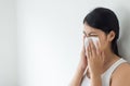 Asian woman with cold blowing and runny nose in home,sick woman sneezing,Concept of health,Close up and selective focus Royalty Free Stock Photo