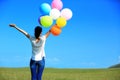 Young asian woman with colored balloons Royalty Free Stock Photo