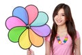 Young asian woman with colorful windmill Royalty Free Stock Photo