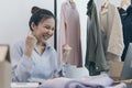 Young Asian woman congratulated and smiled as a large number of customers ordered her clothes online, Business of selling clothes