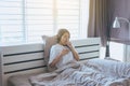 Young asian woman coughing and sitting on her bed Royalty Free Stock Photo