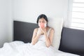 Young asian woman coughing and sitting on her bed,Concept of health Royalty Free Stock Photo