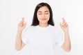 Young asian woman cross fingers for wishing good luck isolated on white background.Template summer t shirt. Copy space Royalty Free Stock Photo