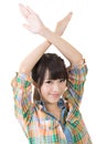 Young asian woman crossed hands overhead