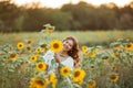 Young Asian woman with curly hair in a field of sunflowers at sunset. Portrait of a young beautiful asian woman in the sun Royalty Free Stock Photo