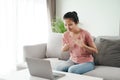 Young Asian woman deaf disabled using laptop computer for online video conference call learning and communicating in sign language Royalty Free Stock Photo