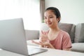 Young Asian woman deaf disabled using laptop computer for online video conference call learning and communicating in sign language Royalty Free Stock Photo