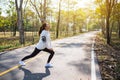 A young asian woman do stretching legs before running Royalty Free Stock Photo