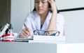 Young woman doctor is thingking and tired with working at hospital Royalty Free Stock Photo