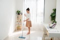 Young Asian woman doing cleaning at the home office Royalty Free Stock Photo