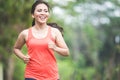 Young asian woman doing excercise outdoor in a park, jogging Royalty Free Stock Photo