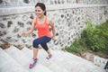 Young asian woman doing excercise outdoor in a park, jogging up Royalty Free Stock Photo