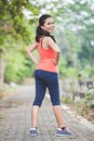 Young asian woman doing excercise outdoor in a park, stretching Royalty Free Stock Photo