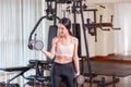 Young asian woman doing exercises with dumbbell in gym Royalty Free Stock Photo