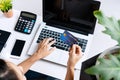 Young Asian woman doing research work for her business with computer laptop while holding credit card at home, top view and copy Royalty Free Stock Photo