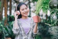 Young Asian woman drinking tea in the garden Royalty Free Stock Photo