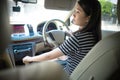 Young asian woman driveing car checking on mirror check behind going reverse keeps wheel turning around. Japanese girl new driver Royalty Free Stock Photo