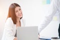 Young asian woman employee smiling with happiness and confident while looking toward camera with a white meeting room background,