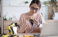 Young Asian woman engineer programer working on robotics project at home.