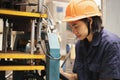Young asian woman engineer set up and testing machine in the laboratory factory