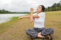 Young asian woman enjoying and relaxing on the green grass Royalty Free Stock Photo