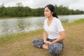 Young asian woman enjoying and relaxing on the green grass Royalty Free Stock Photo