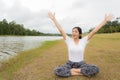 Young asian woman enjoying and relaxing on the green grass Royalty Free Stock Photo