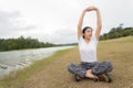 Young asian woman enjoying and relaxing on the green grass Royalty Free Stock Photo