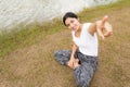 Young asian woman enjoying and relaxing on the green grass Royalty Free Stock Photo