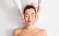 Young asian woman enjoying skin lifting face massage at wellness center Royalty Free Stock Photo