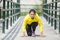 Young asian woman exercising outdoor in yellow neon jacket Royalty Free Stock Photo