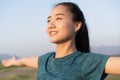 Young Asian women are exercising with yoga while standing outdoor in summer at morning, Asia girl take care of their health with Royalty Free Stock Photo